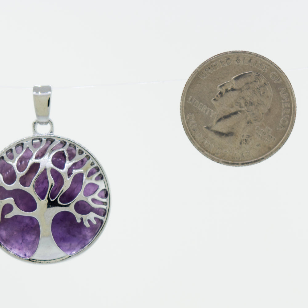 
                  
                    A beautiful Super Silver Tree of Life pendant adorned with a round purple stone.
                  
                