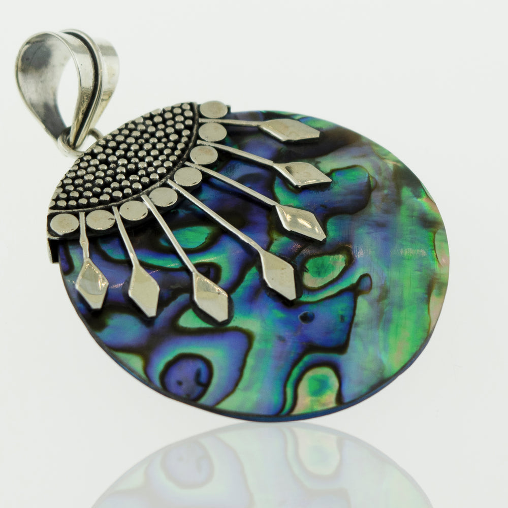 A Super Silver Circle Abalone Pendant with Bali detail made of .925 Sterling Silver, placed on a white surface.