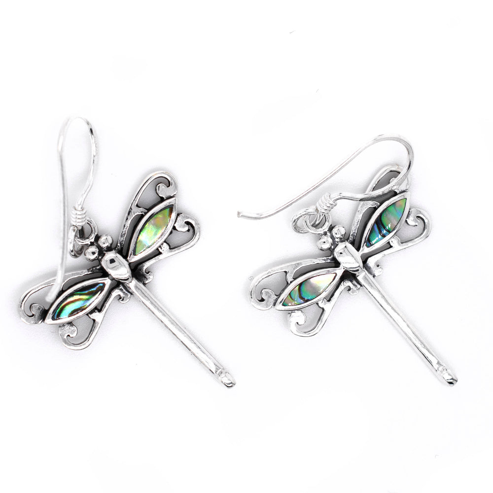 
                  
                    A pair of Dragonfly Abalone earrings on a Super Silver background.
                  
                