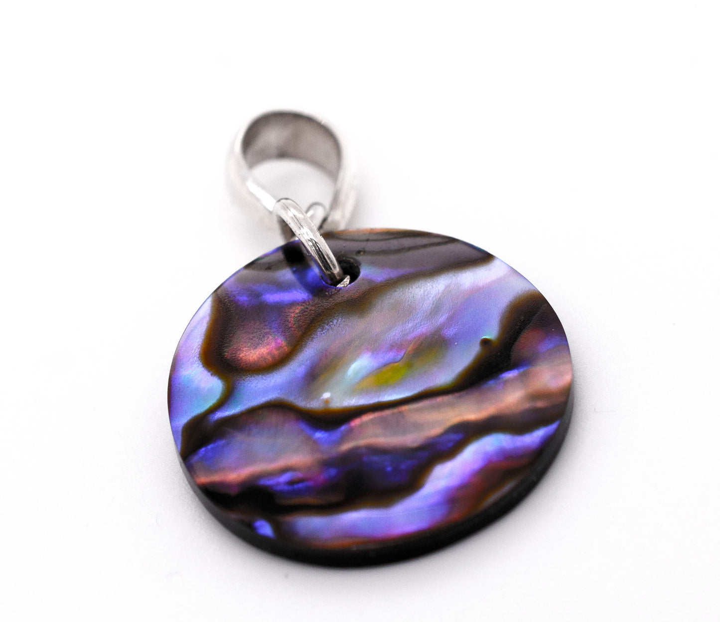 A handmade Super Silver Charming Abalone Pendant showcasing its healing properties, placed delicately on a pristine white surface.