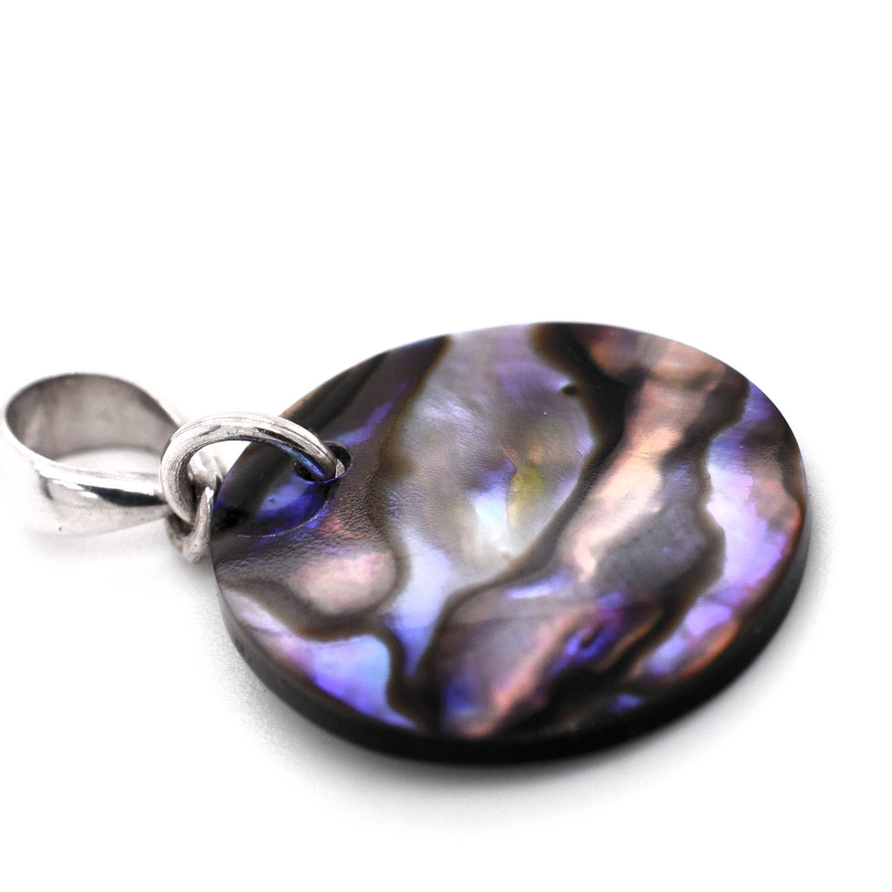 
                  
                    A Super Silver Charming Abalone Pendant showcasing its stunning iridescent colors on a white background.
                  
                