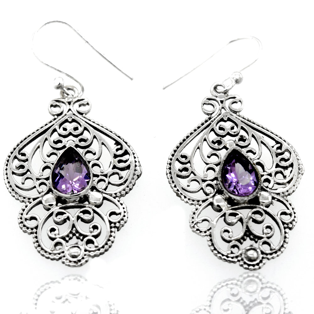 A pair of Super Silver Teardrop Amethyst Earrings with Freestyle Silver Design in a silver setting.