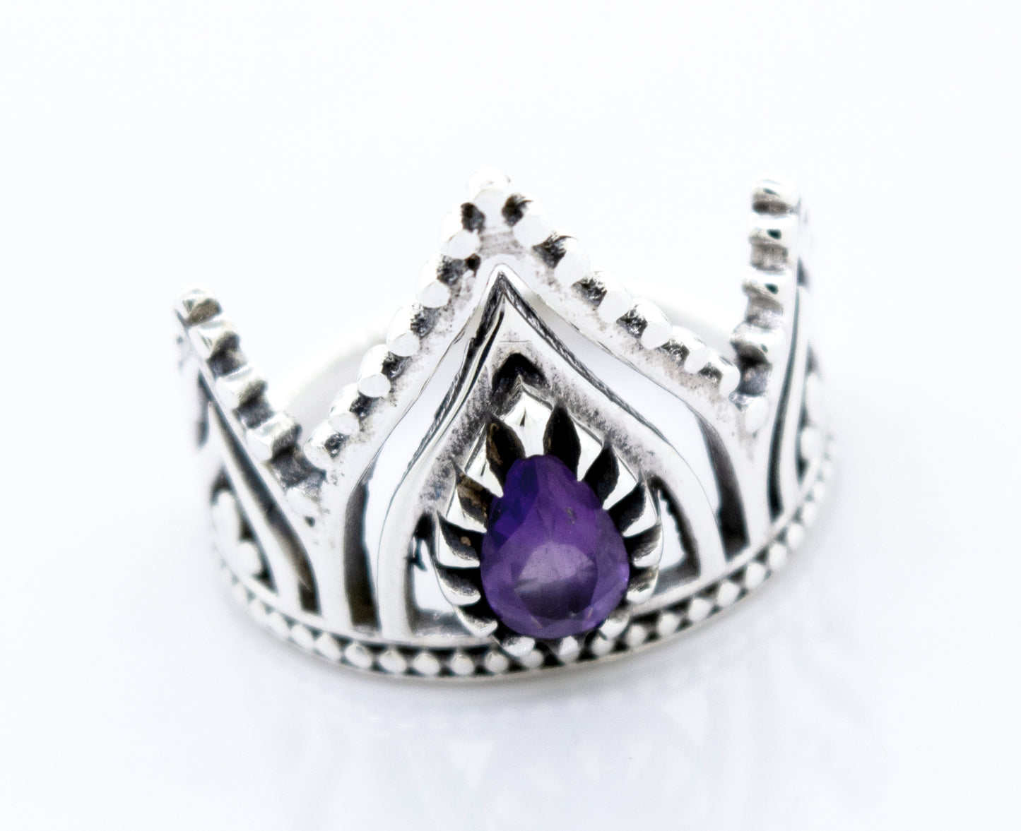 
                  
                    A Super Silver crown ring with a teardrop-shaped amethyst set on a white surface.
                  
                