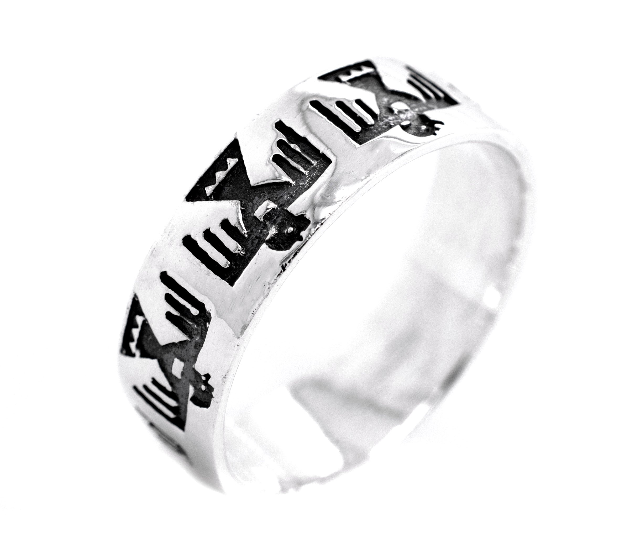 A silver Super Silver Thunderbird Ring with black and white designs featuring a thunderbird.