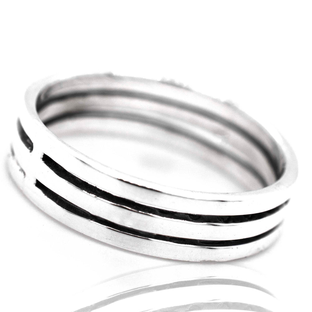 
                  
                    A Super Silver Triple Stripe Band with black stripes and cutouts on a plain silver band.
                  
                