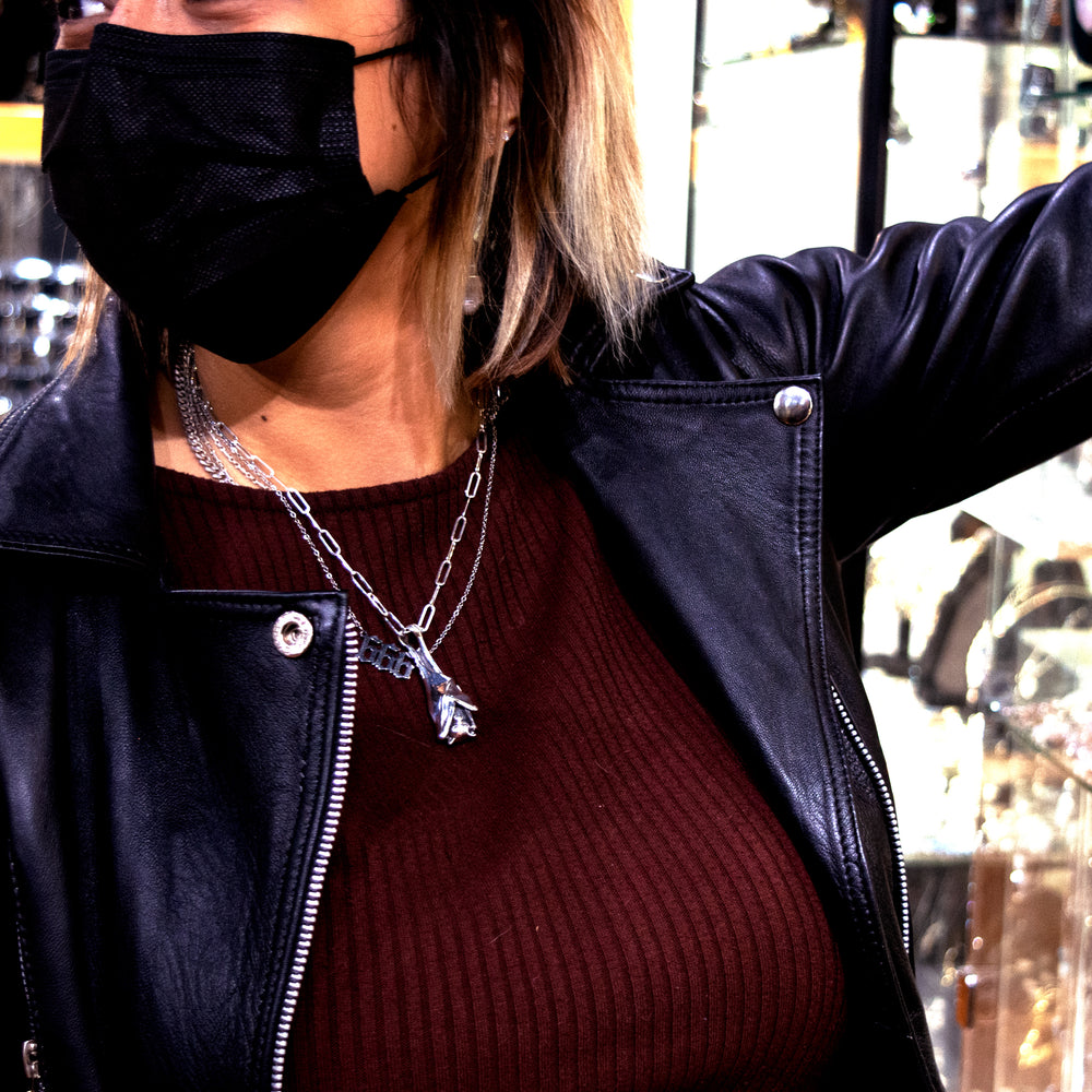 
                  
                    A woman wearing a Super Silver Designer Handcrafted Bat Pendant mask in a jewelry store.
                  
                