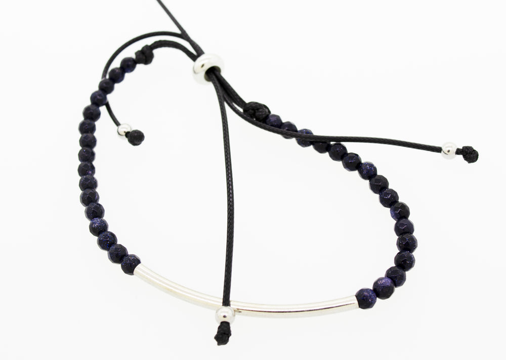 A versatile style adjustable gemstone bead bracelet featuring a silver bar and black beads by Super Silver.
