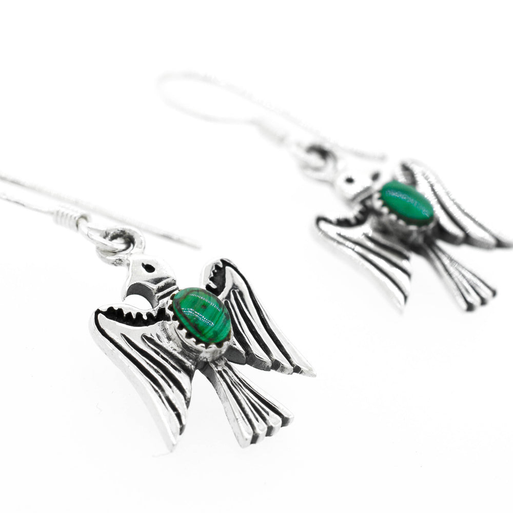 
                  
                    Super Silver's Malachite Thunderbird Earrings with green malachite stones are inspired by Native American culture.
                  
                