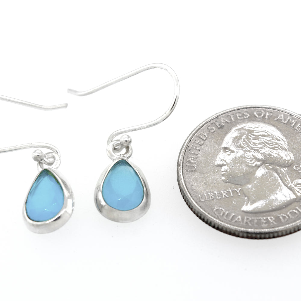 
                  
                    A pair of Simple Teardrop Shape Blue Chalcedony Earrings by Super Silver with a blue opal stone in a sterling silver setting.
                  
                