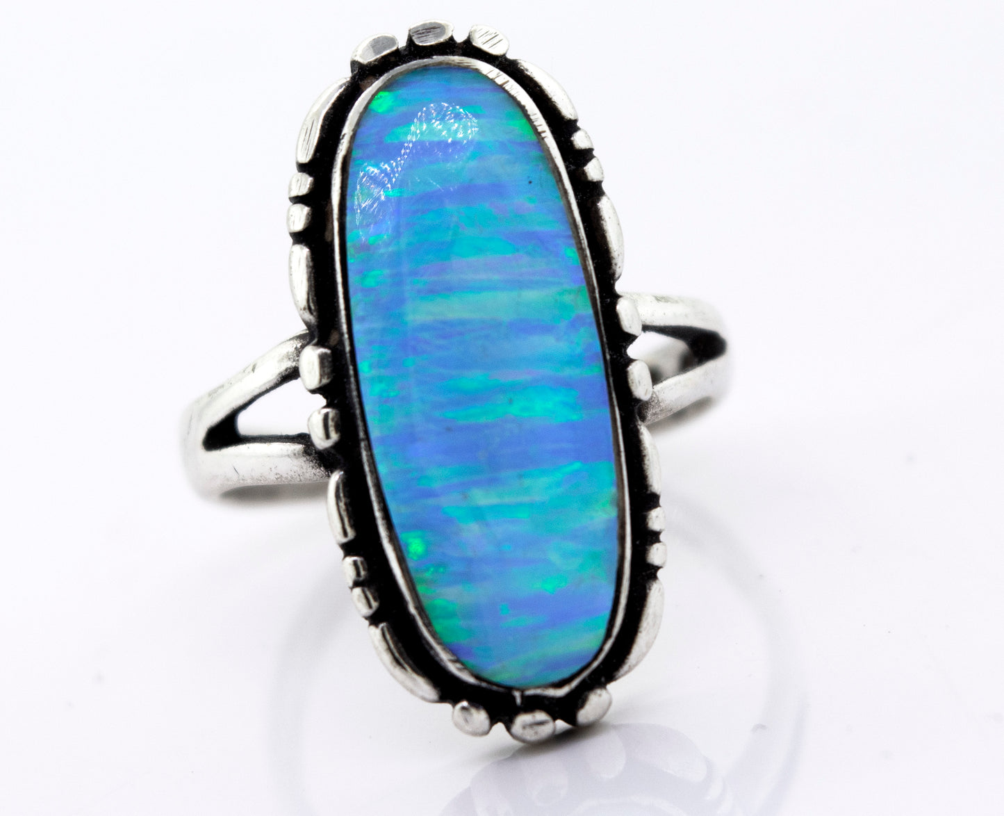 
                  
                    A handcrafted American Made Oval Opal Ring with a southwestern-styled design on a white surface, from the brand Super Silver.
                  
                