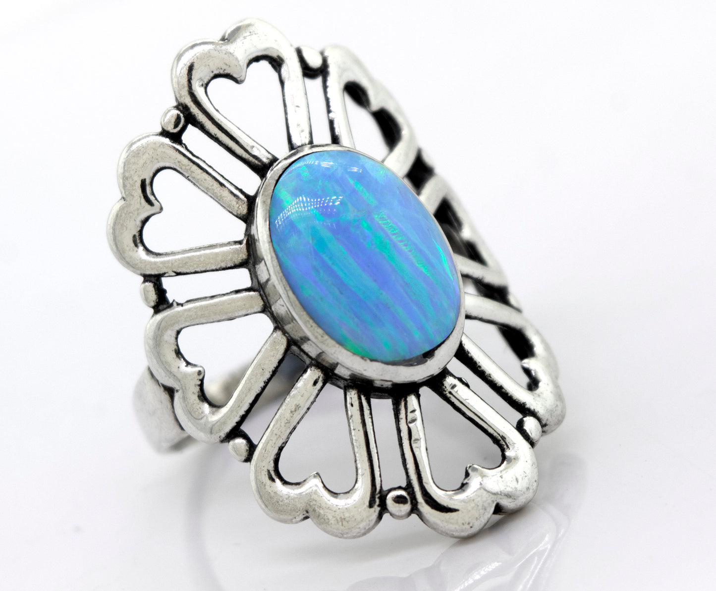 
                  
                    A Super Silver American Made Opal Flower Ring with Heart Shaped Petals, featuring a stunning blue opal in the center and a delicate flower design.
                  
                