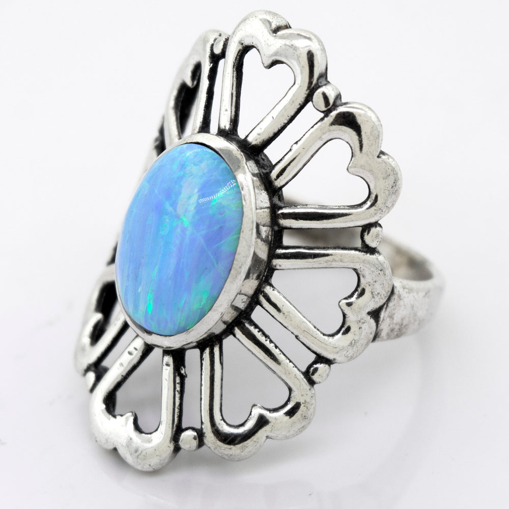 
                  
                    A handcrafted, Super Silver American Made Opal Flower Ring with Heart Shaped Petals in the center.
                  
                