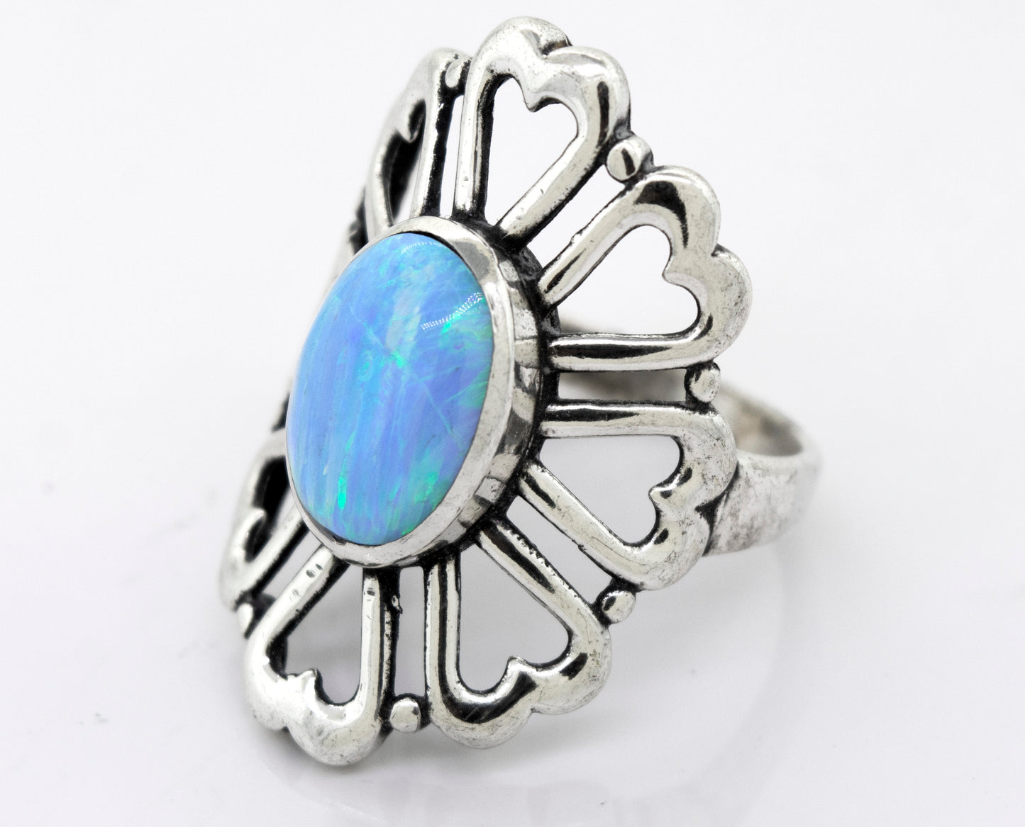 
                  
                    A handcrafted, Super Silver American Made Opal Flower Ring with Heart Shaped Petals in the center.
                  
                