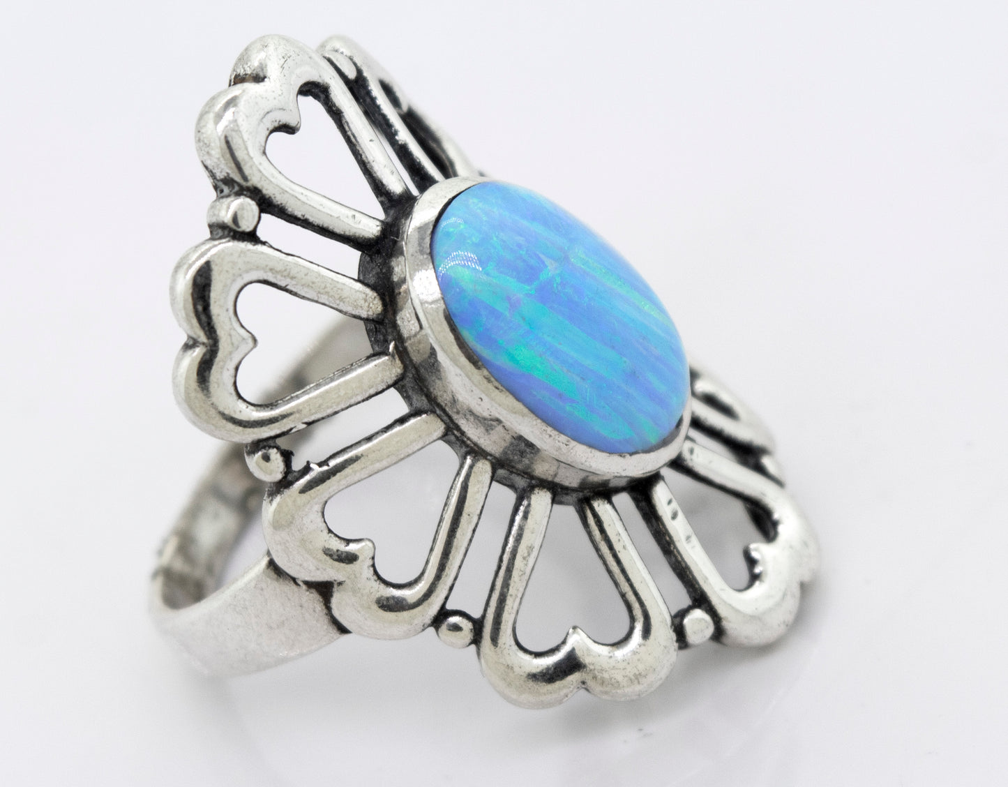 
                  
                    A Super Silver American Made Opal Flower Ring with Heart Shaped Petals featuring a beautiful blue opal stone.
                  
                