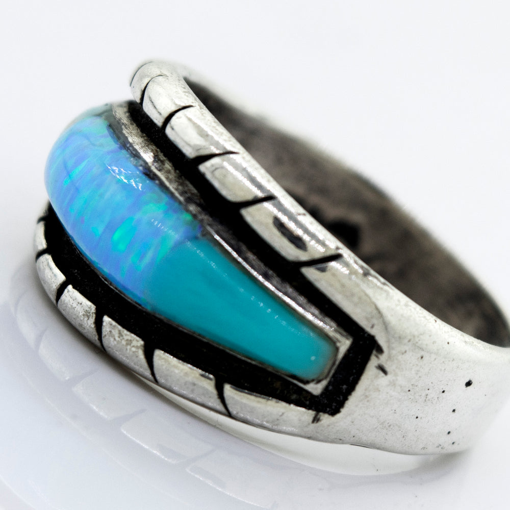 
                  
                    A Super Silver American Made Opal Inlay Ring with a blue opal stone in it.
                  
                