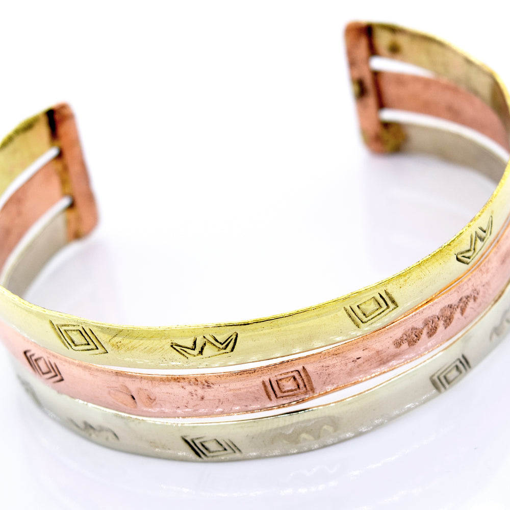 Three Gold Plated Bracelet With Freestyle Engraving cuff bracelets in different colors with Super Silver branding.