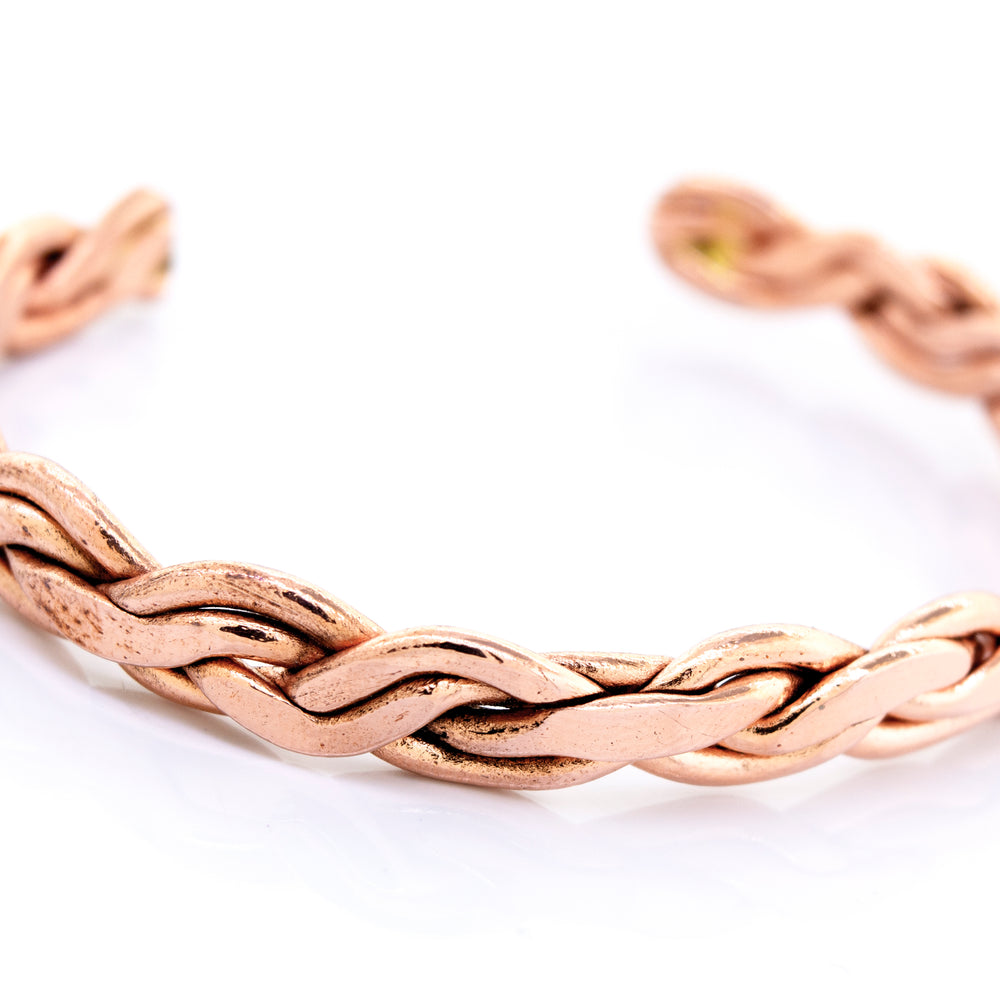 A Super Silver copper bracelet with a braided weave design.