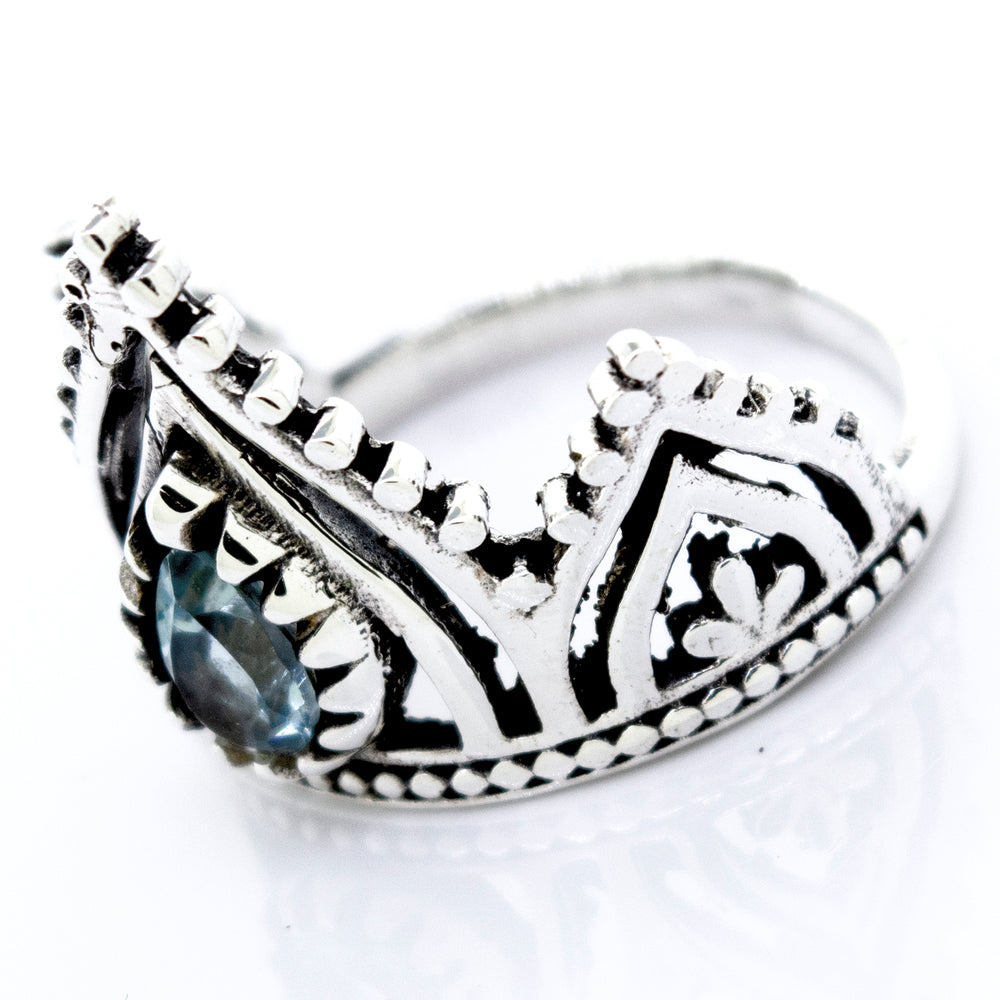 A Super Silver Crown Ring With Teardrop Shape Blue Topaz on it.