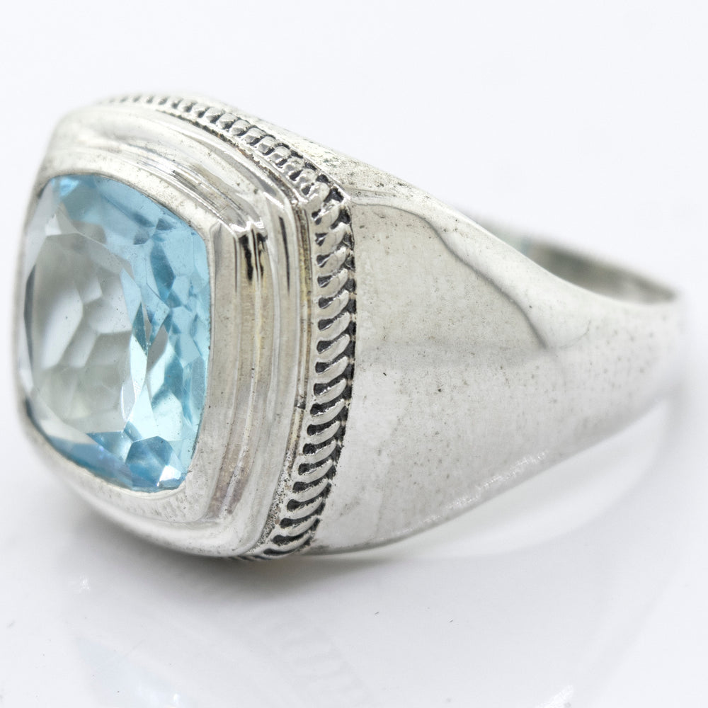 
                  
                    Faceted Stone Signet Ring with a square-cut light blue Blue Topaz gemstone in a pronged setting, displayed against a plain white background.
                  
                
