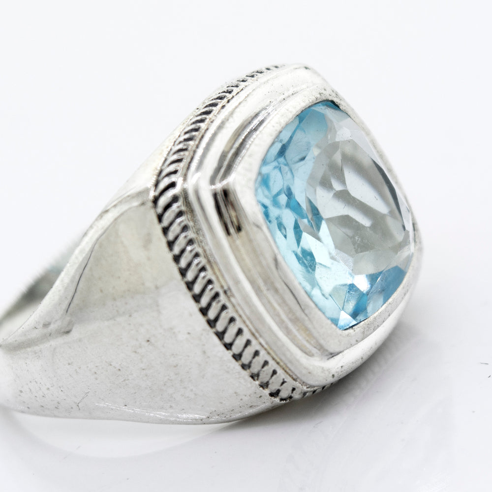
                  
                    A minimalist sterling silver ring with a Blue Topaz Signet Ring.
                  
                