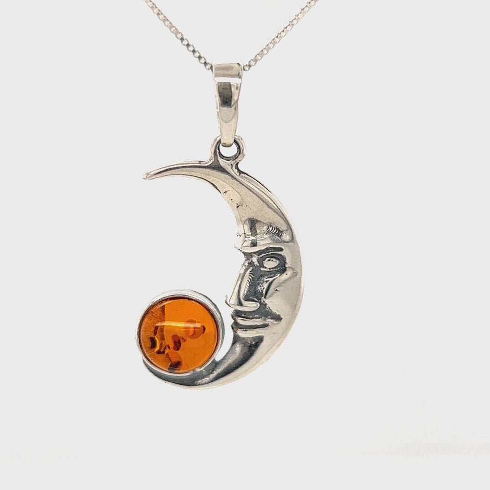 
                  
                    Load and play video in Gallery viewer, Baltic Amber Man in the Moon Pendant
                  
                