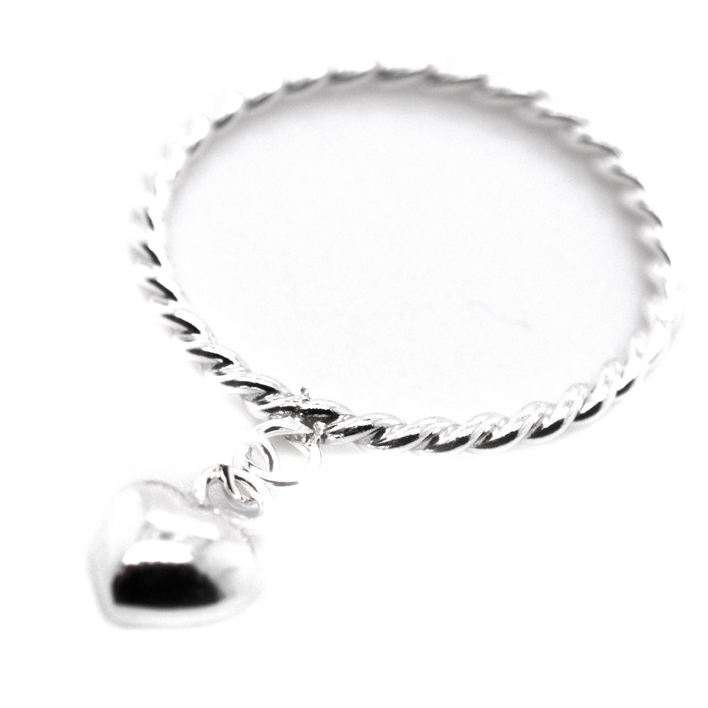 
                  
                    A minimalist Super Silver stacking ring adorned with a Heart Charm Ring With Rope Band.
                  
                