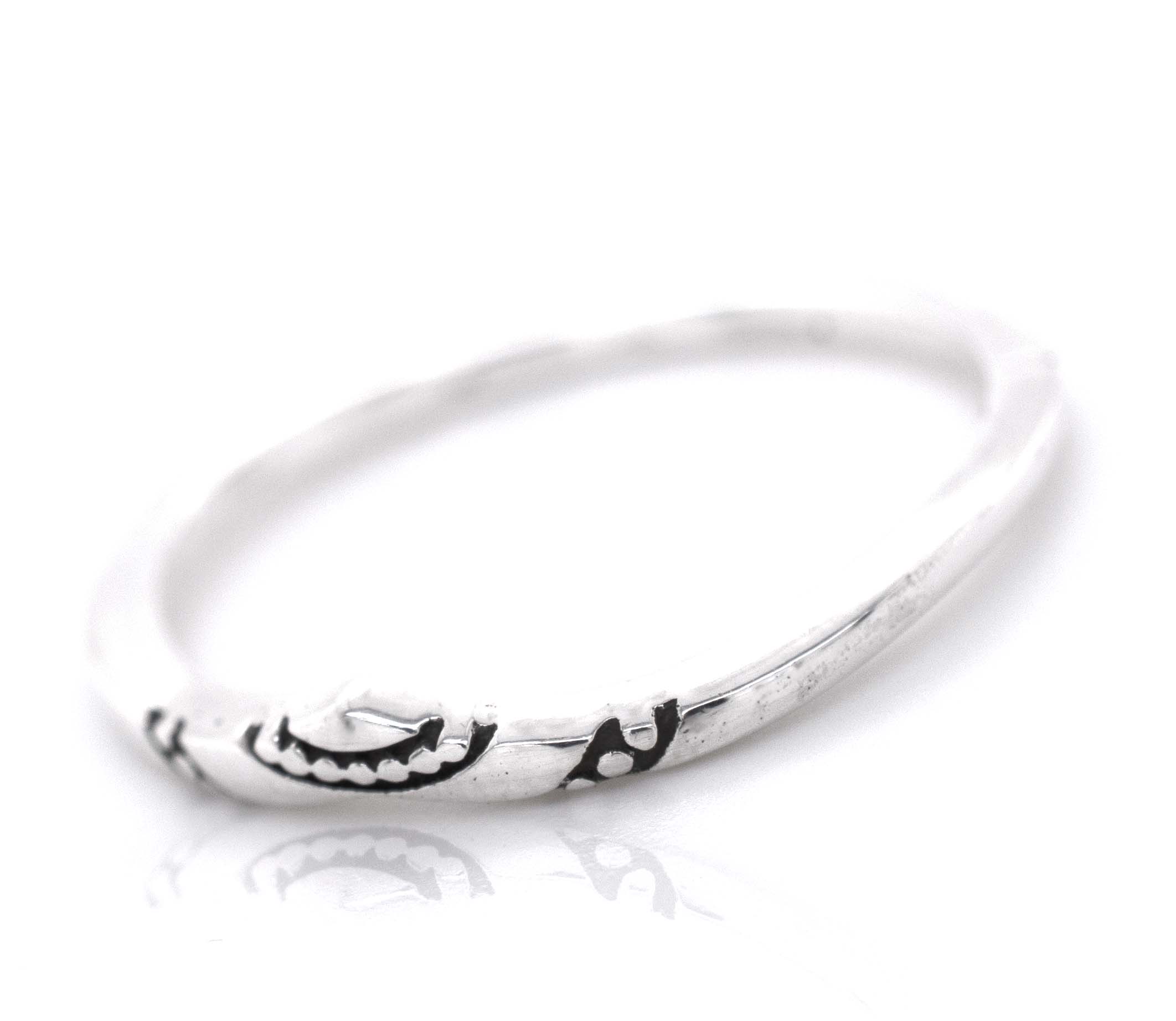 A minimalist Dainty Chevron Band With Etched Design.