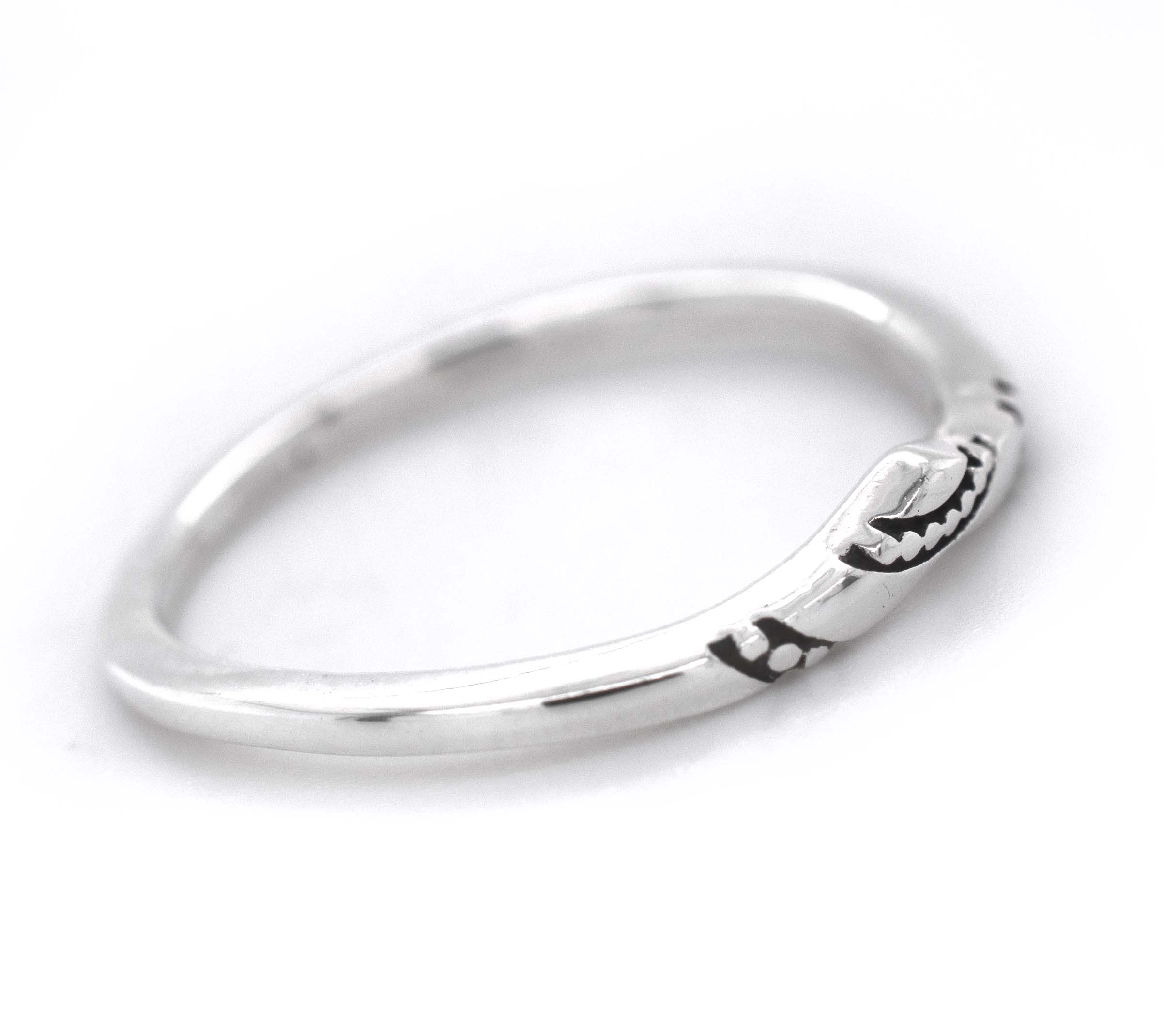 A stackable Dainty Chevron Band With Etched Design made of sterling silver.
