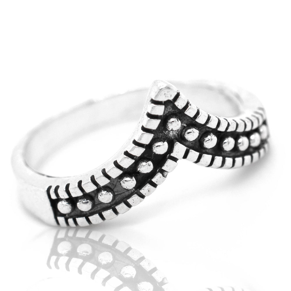 A Striking Chevron Ring with black and white dots.