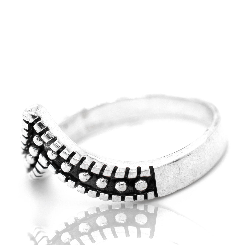 
                  
                    A stackable Striking Chevron Ring with black and white dots.
                  
                