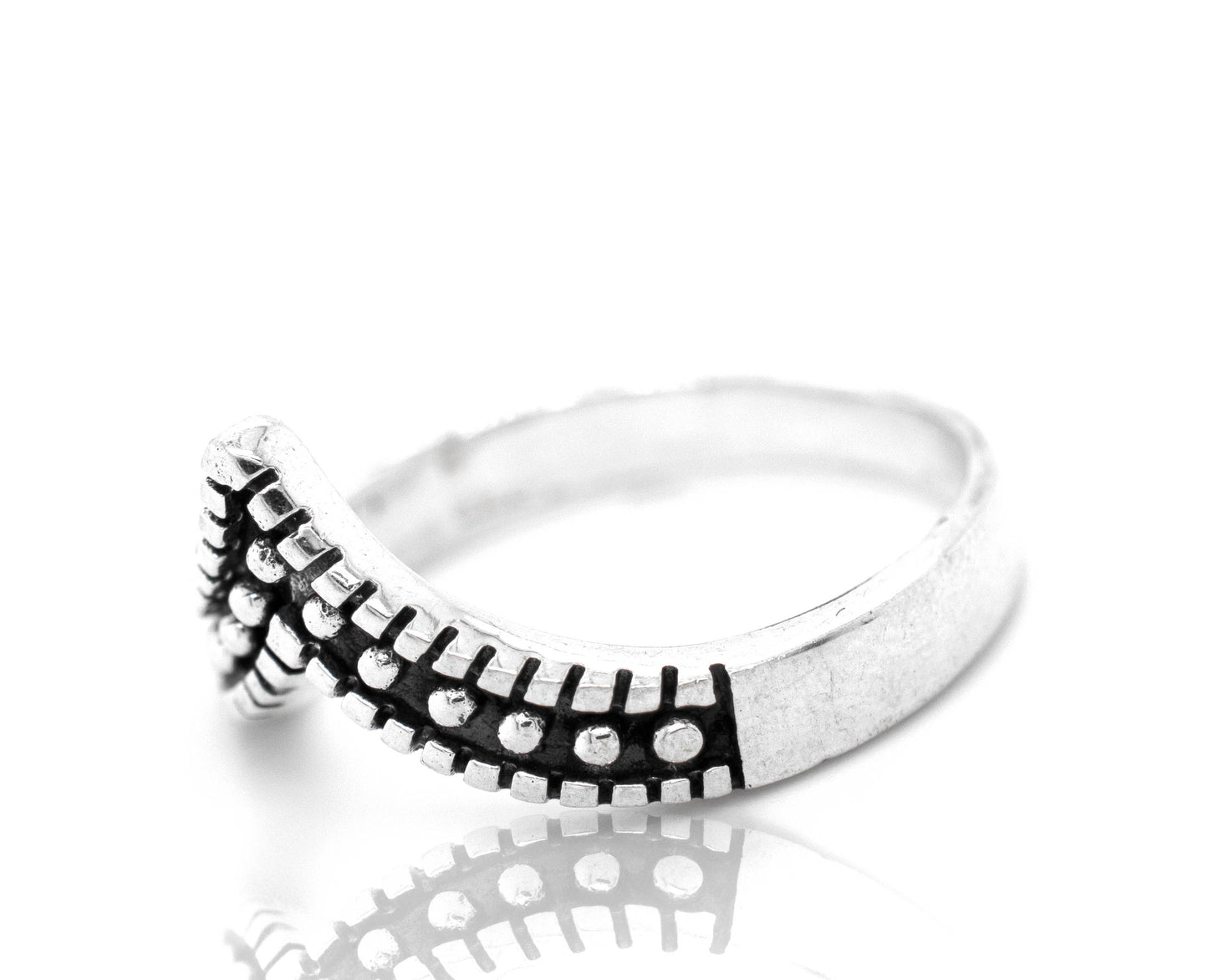 
                  
                    A stackable Striking Chevron Ring with black and white dots.
                  
                