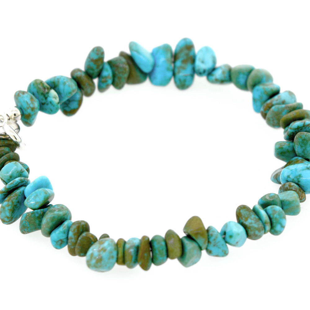 
                  
                    A Southwest Colorado Turquoise Chip Bracelet or Anklet made of irregularly shaped turquoise stones in varying shades of blue and green, arranged in a single strand with a .925 Sterling Silver clasp, exuding southwest charm.
                  
                