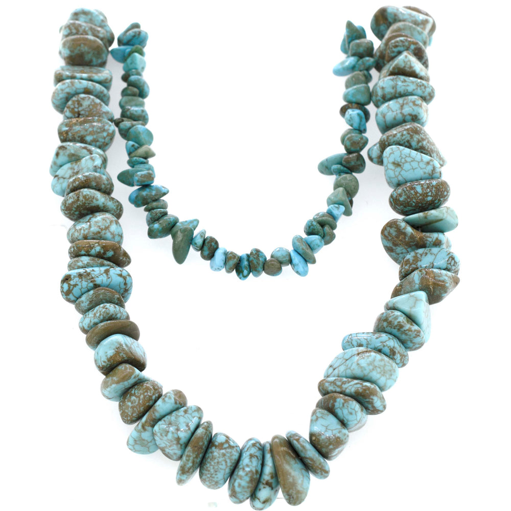 
                  
                    A Super Silver southwest charm necklace adorned with Southwest Colorado Turquoise Chip and brown stones.
                  
                