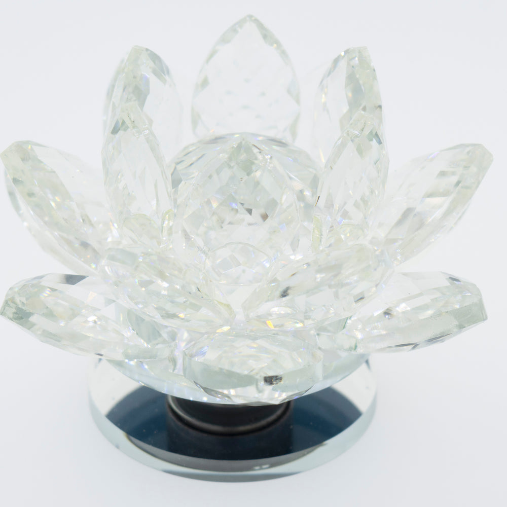A Crystal Lotus Stand on a white background, illuminating its mesmerizing beauty.