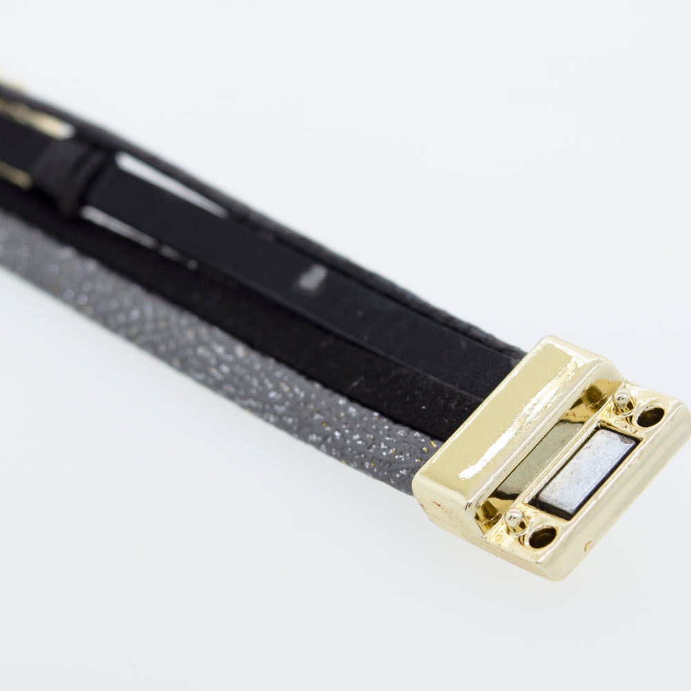
                  
                    A Super Silver Black Magnet Bracelet with a gold clasp.
                  
                