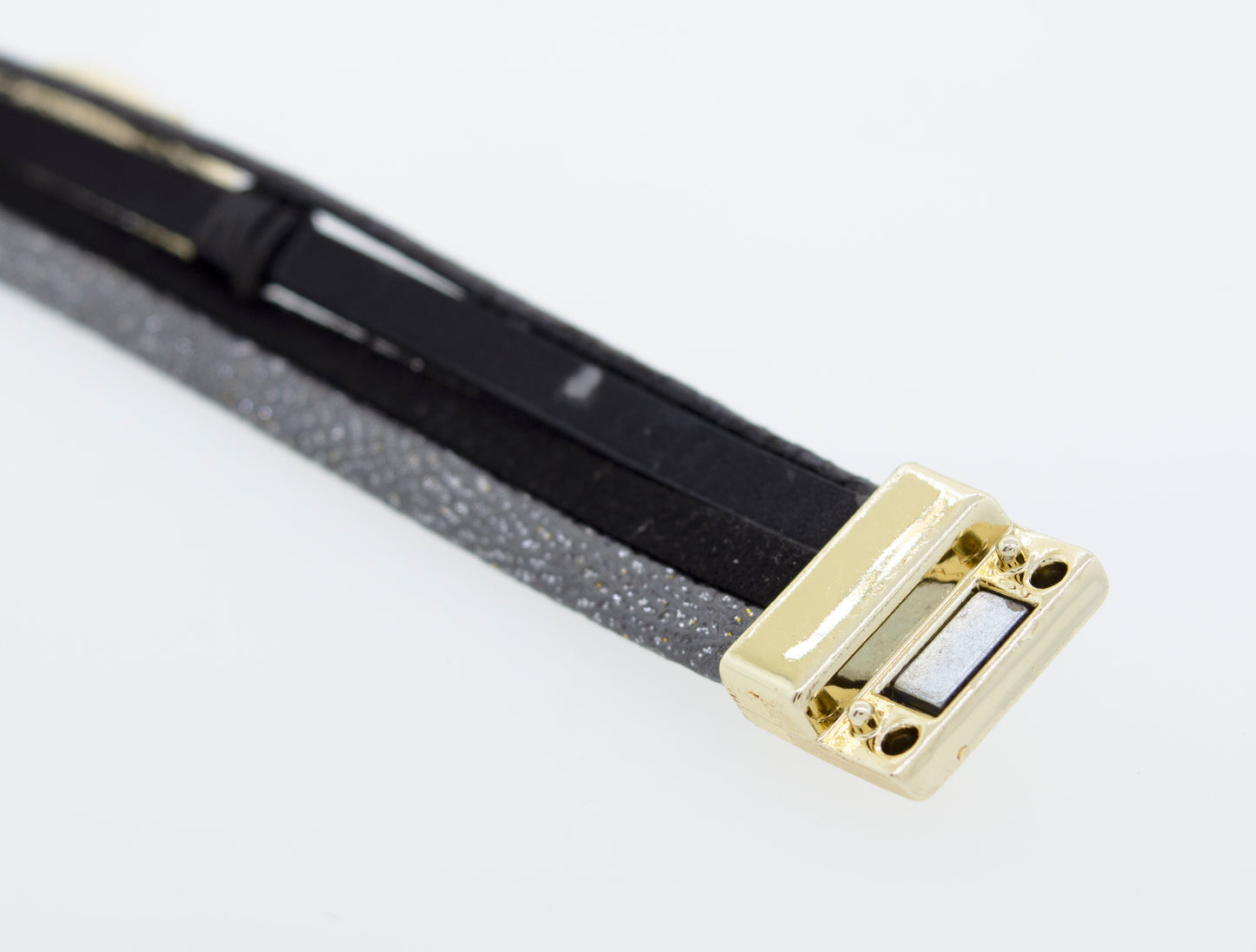 
                  
                    A Super Silver Black Magnet Bracelet with a gold clasp.
                  
                