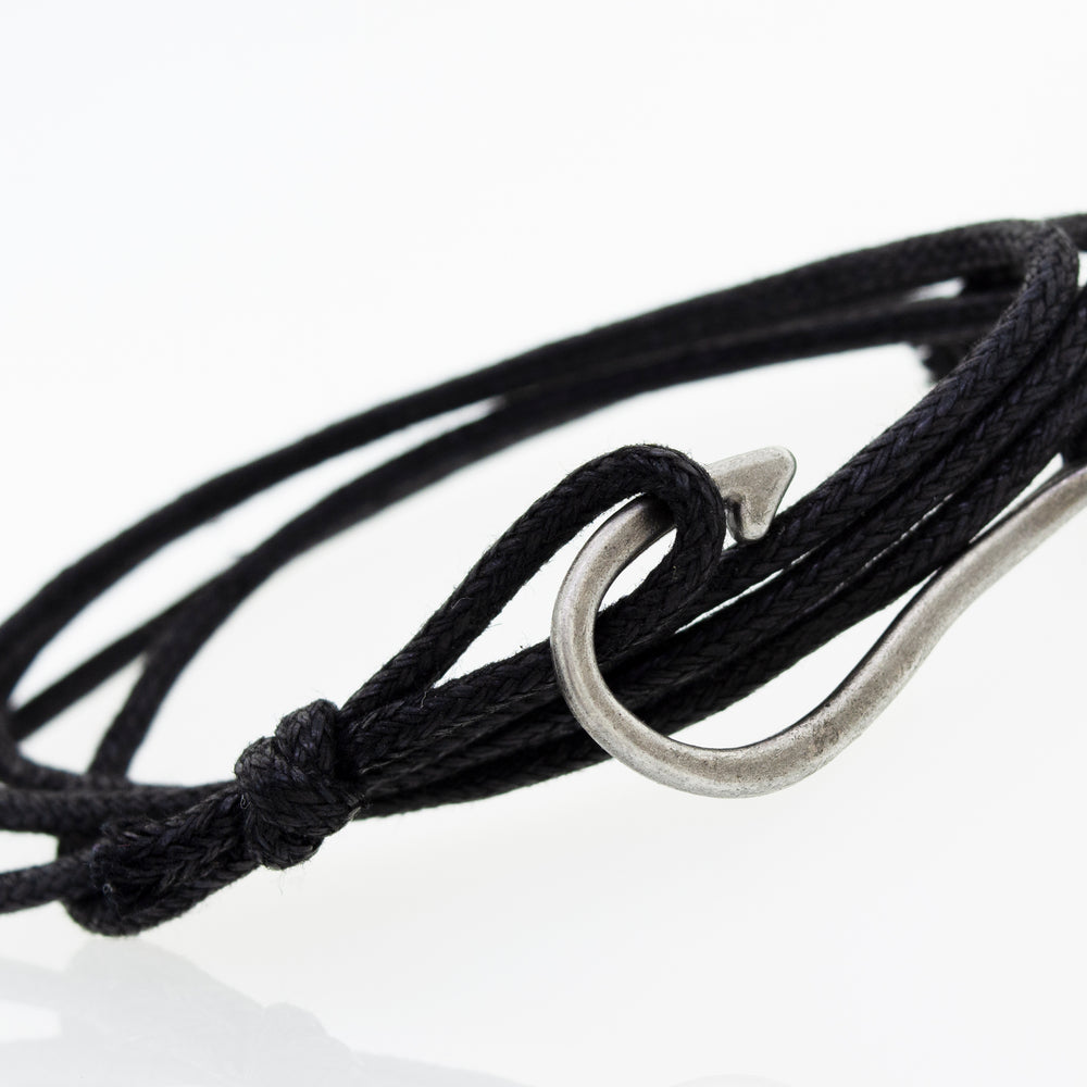 
                  
                    A Three Bracelet Set by Super Silver, consisting of a black chord bracelet with a hook and beads.
                  
                