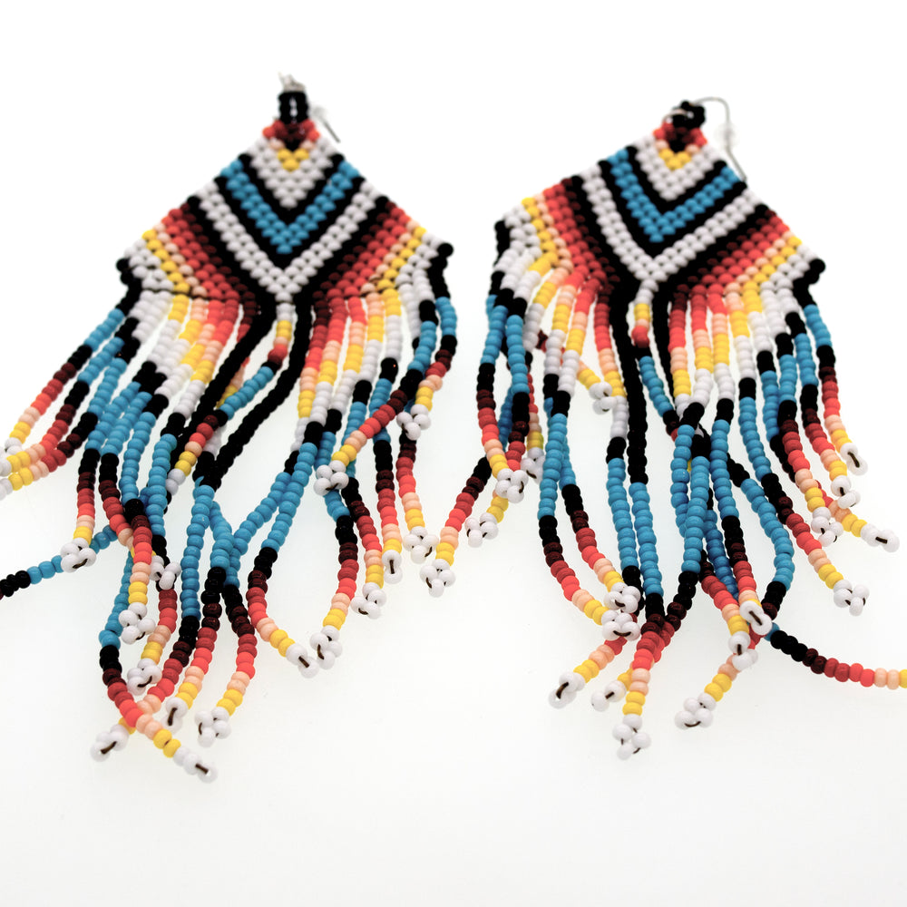 
                  
                    A pair of long and colorful Super Silver Handmade Southwest inspired Earrings with fringes, handmade from surgical steel.
                  
                
