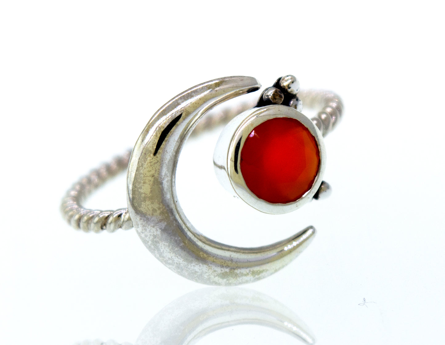 
                  
                    An Online Only Exclusive Adjustable Carnelian Ring with a silver crescent design and an orange carnelian crystal stone.
                  
                
