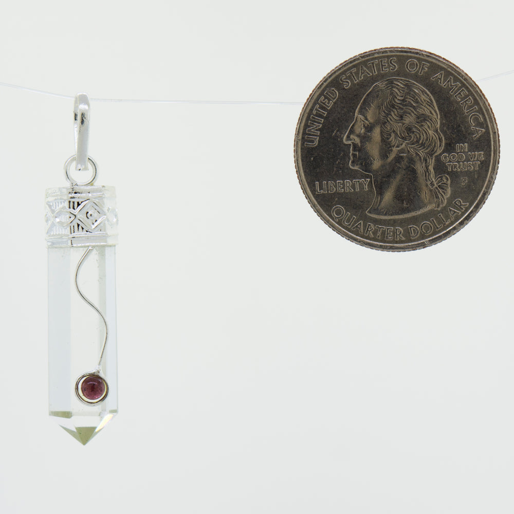 
                  
                    A Super Silver Crystal Pendant with Decorative Bail, suspended by a delicate chain, with a penny hanging from it.
                  
                