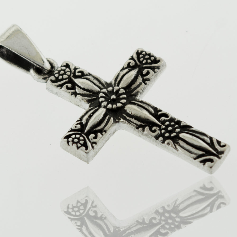 A Super Silver Cross Pendant With Flower Detail with an ornate design.