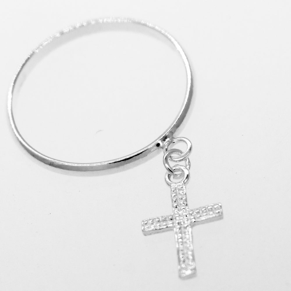 
                  
                    A simple Super Silver bangle with a Charm Ring with Cross charm.
                  
                