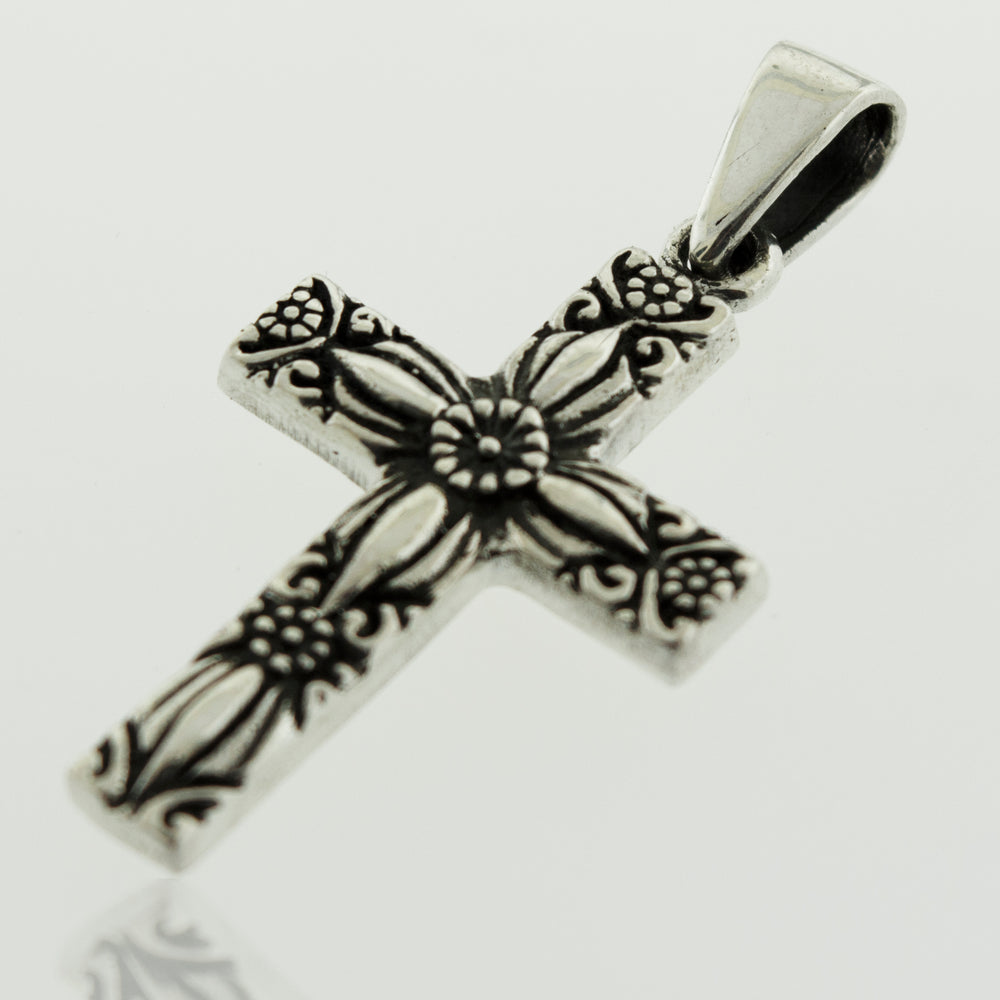 A Super Silver Cross Pendant With Flower Detail featuring a floral design.