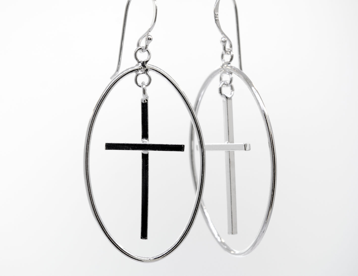 
                  
                    Super Silver's Modern Cross Earrings featuring an oval wire design casing and a .925 Silver finish.
                  
                