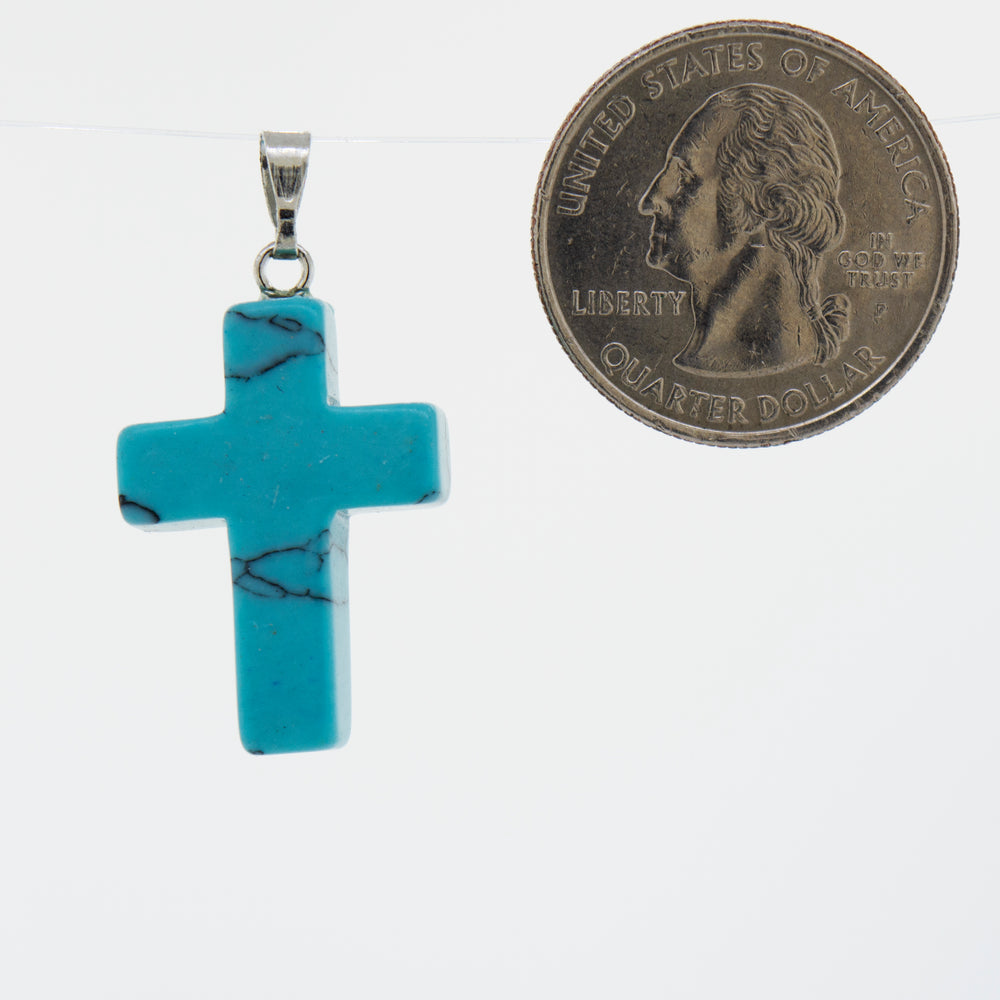 A Super Silver turquoise stone cross pendant on a necklace.