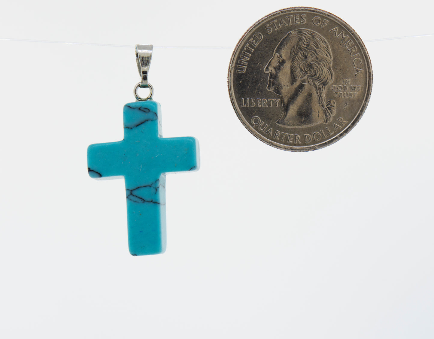 A Super Silver turquoise stone cross pendant on a necklace.