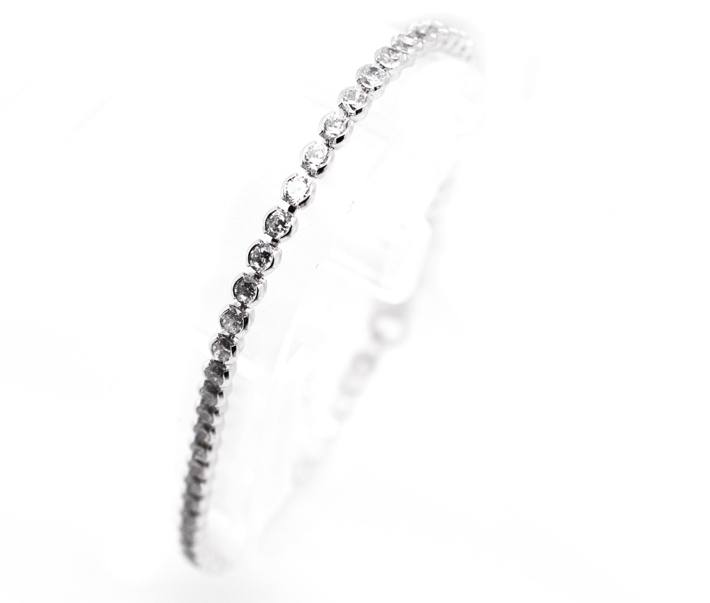 An elegant Super Silver Round Cubic Zirconia Tennis Bracelet with dainty diamonds on it.