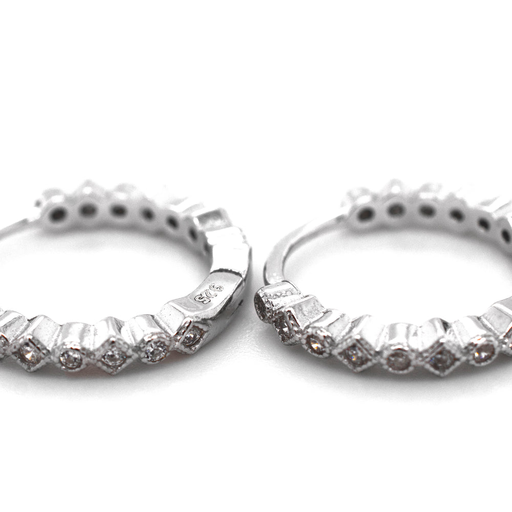 A pair of Fashionable Geometric CZ Hoops by Super Silver with diamonds.