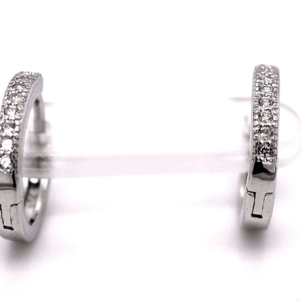 
                  
                    A pair of Small Pave Cubic Zirconia Hoops by Super Silver adorned with sparkling diamonds.
                  
                