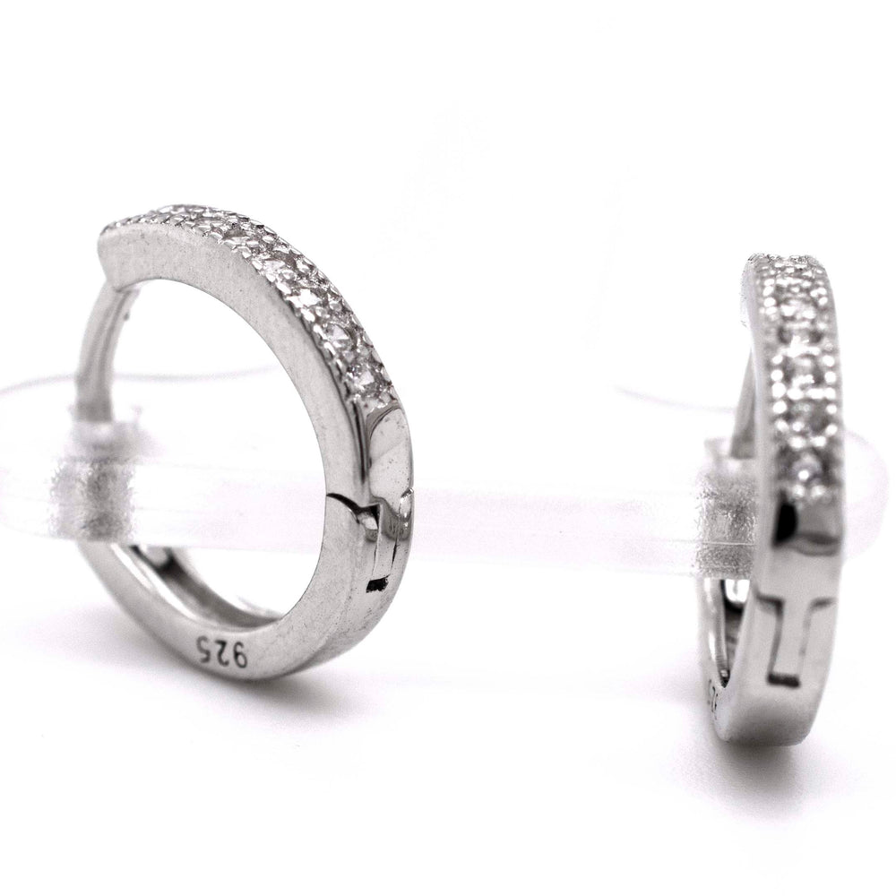 
                  
                    A pair of Super Silver Small Pave Cubic Zirconia Hoops with diamond alternative cubic zirconia.
                  
                